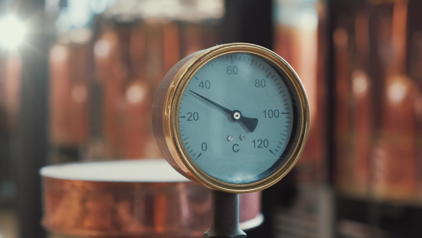 Manometer at background of copper brewery tanks close up