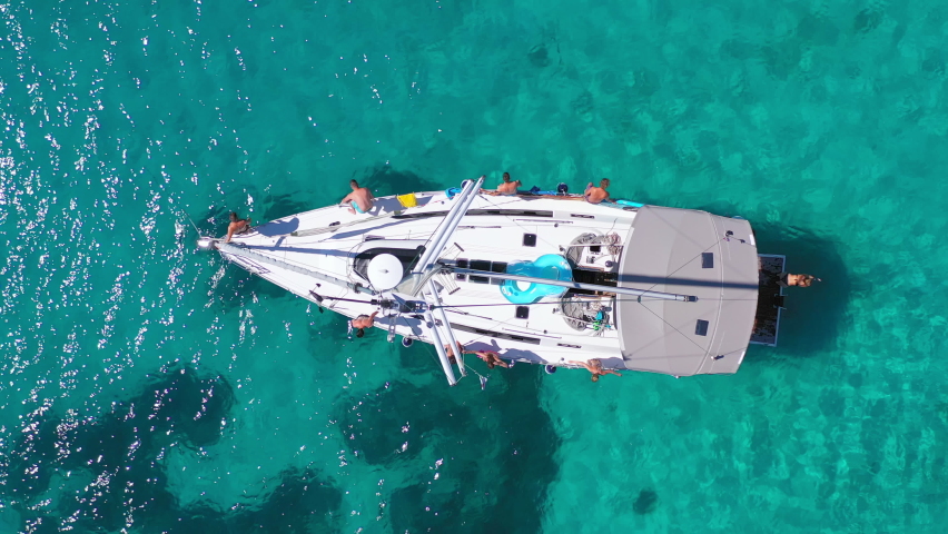 Top view of young friends jumping from sailboat. Yachting. Sail boat party day. Summer luxury boat trip Royalty-Free Stock Footage #1088893131