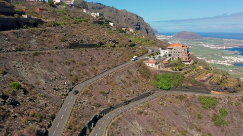 4K drone aerial shot of vacation villa sitting on steep cliff above historical village of Garachico, above the coast of Atlantic Ocean in north Tenerife, Canary Islands