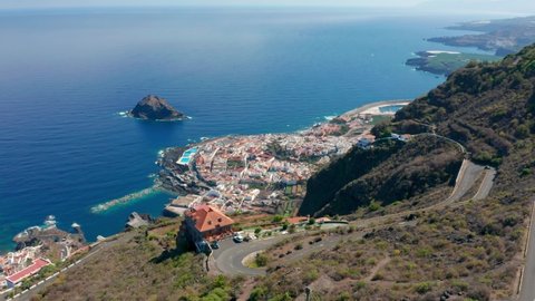 4K drone aerial shot of little historical town and port Garachico right on the coast of Atlantic Ocean in north Tenerife, Canary Islands