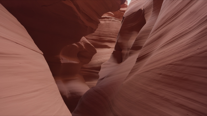 Inside the Upper Antelope Canyon. Cinematic landscape with astonishing high walls of the red sandstone formations with bright sunlight above. High quality 4k footage Royalty-Free Stock Footage #1088896807