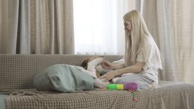 Young Beautiful Girl Playing With Dog On Bed