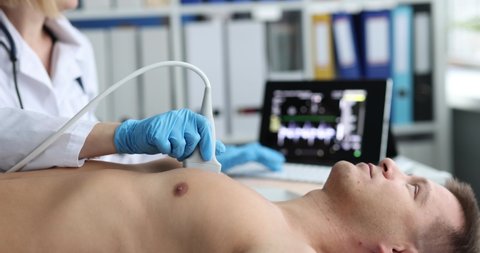 Doctor makes chest x-ray to man on ultrasound scanner closeup