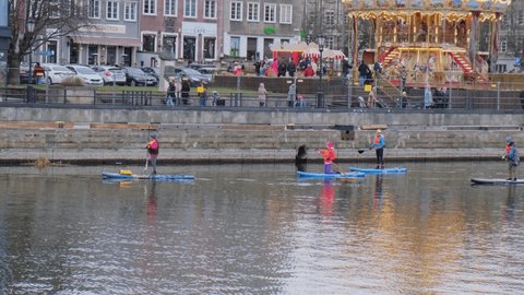 Gdansk Poland March 2022 Group of sup surfers stand up paddle board, women stand up paddling together in the city Motlawa river and canal in old town Gdansk Poland. Tourism attraction Active outdoor
