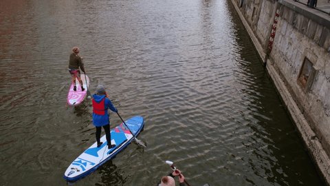 Gdansk Poland March 2022 Group of sup surfers stand up paddle board, women stand up paddling together in the city Motlawa river and canal in old town Gdansk Poland. Tourism attraction Active outdoor