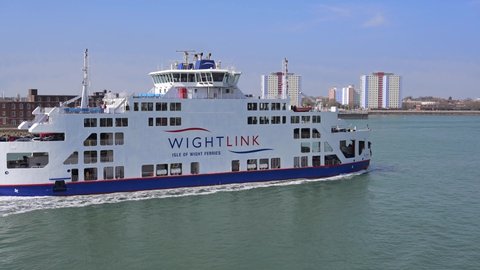 Portsmouth, Hampshire, UK, March 25, 2022. Wight Link ferry St Clare arrives into Portsmouth Harbour with Gosport in the background.