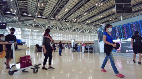 BANGKOK, THAILAND - Mar 28, 2022: Timelapse of Many tourists and passengers are walking in the suvarnabhumi airport, Thailand
