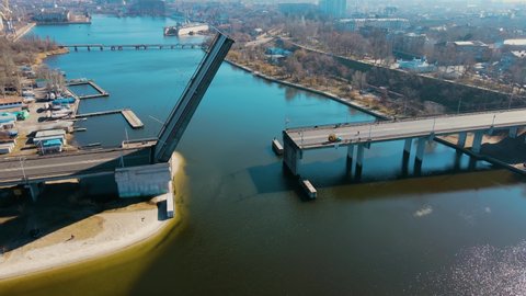 Raised drawbridge over river near ship harbor in Nikolaev Ukraine. Concept of logistics of roads and waterways