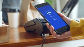 Customer using smartphone for NFC payment at cafe restaurant, cashless, contactless technology and money transfer concept - Powered by Shutterstock - Get 15% off with code: PIKWIZARD15