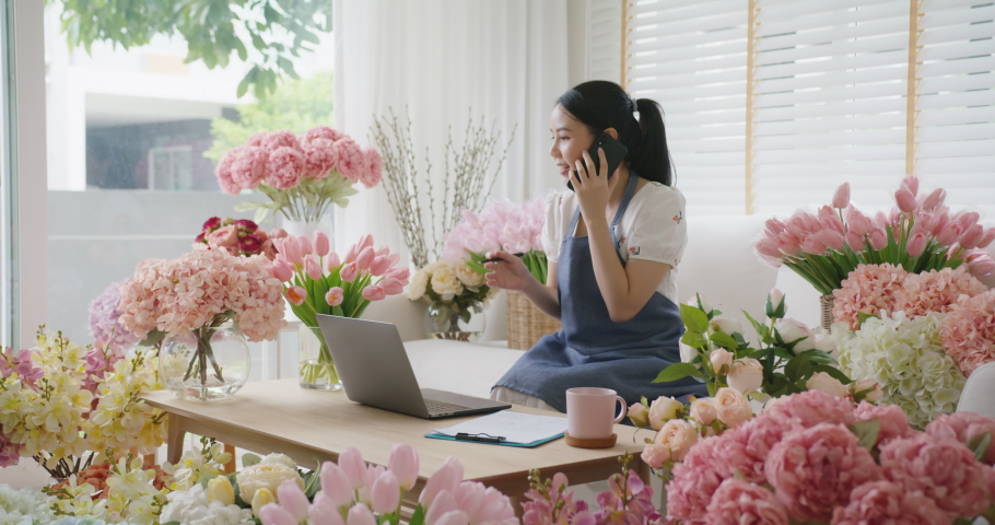 Asia people young Gen Z girl SME owner smile happy work at home office talk on mobile sell product at modern florist gift shop. Online digital marketplace web sale page telesale in social media. Royalty-Free Stock Footage #1088905657