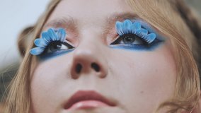 Original makeup for the model. Flower petals on the lashes. - Powered by Shutterstock - Get 15% off with code: PIKWIZARD15