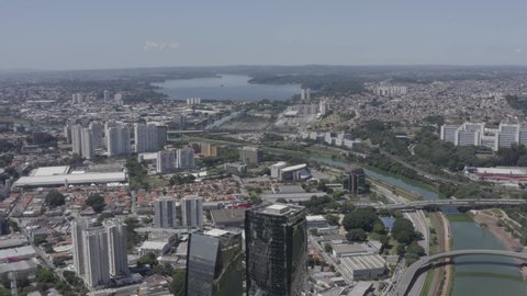 Marginal Pinheiros avenue with mirrored buildings with guarapiranga dam in the background