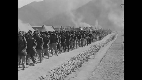 CIRCA 1951 - North Korean POWs sing a Song of Loyalty while they march.