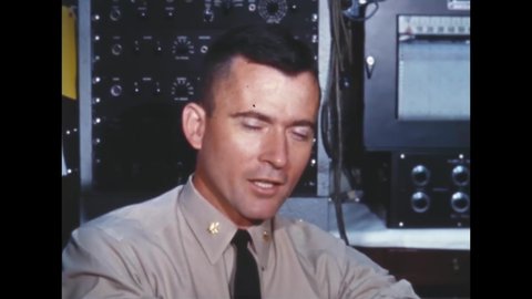 CIRCA 1960s - Astronaut John Young speaks with a doctor at the Flight Medicine Laboratory.
