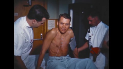 CIRCA 1960s - Physicians prepare astronaut Elliott See for a checkup.