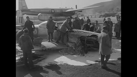 CIRCA 1950 - Australian airmen inspect the wreckage of a shot down F-51.