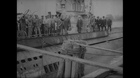 CIRCA 1918 - US military personnel and civilians disembark from a docked ship, some of them getting into a car.