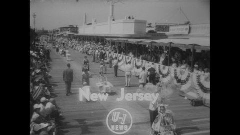 CIRCA 1952 - The annual baby parade takes place on the boardwalk in Wildwood, New Jersey, where some kids are happy to ride on floats.