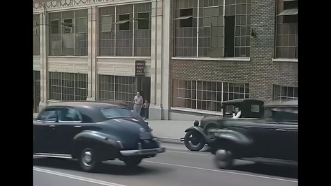 CIRCA 1940s - A camera fixed on a car is driven down up a busy street in San Francisco, California.