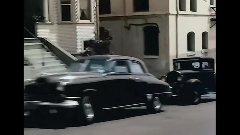 CIRCA 1940s - A camera fixed on a car is driven through a neighborhood in San Francisco, California.