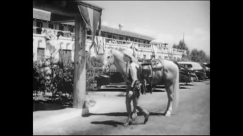 CIRCA 1946 - In this western film, Roy Rogers enters a Pony Express office where the Sons of the Pioneers are singing.