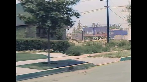 CIRCA 1940s - A car drives through a residential neighborhood in Burbank, California.