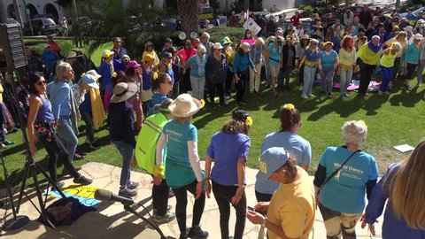 SANTA BARBARA, CALIFORNIA - CIRCA 2022 - Ukranians and anti war protesters dance in a circle and pray together during a Ukraine peace rally.