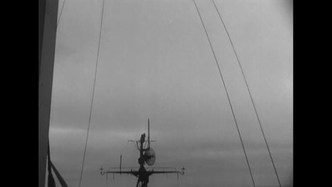 CIRCA 1950 - The UN flag is hoisted aboard the USS Missouri.