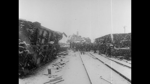 CIRCA 1954 - Rescue workers are hampered by a snowstorm after a horrendous train crash in Korea.