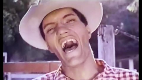CIRCA 1964 - In this comedy movie, ranch hands laugh watching a cowboy try to rope a calf.