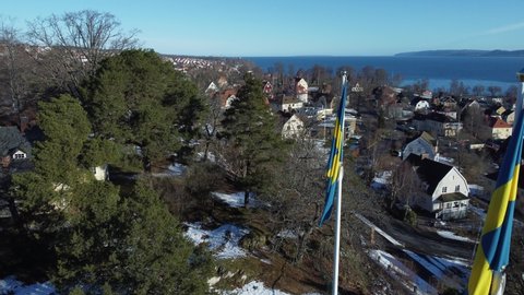 Swedish flag in Jonkoping Sweden, Lake Vättern as a backdrop