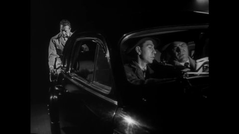 CIRCA 1948 - In this film noir, a service station attendant fuels up a gangster's car and cleans the windshield.