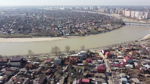 Krasnodar, Russia - March, 14, 2021: The city and the Kuban River from a bird's-eye view. 4K.