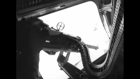 CIRCA 1945 - The waist gunner and pilot of a B-24 work at their instruments.