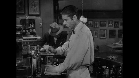 CIRCA 1949 - In this film noir, a soda jerk exchange jokes with a regular customer.