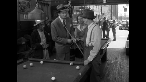CIRCA 1949 - In this film noir, two men play billiards.