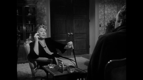 CIRCA 1949 - In this film noir, a gangster receives instructions from his female boss about how to handle a troublesome woman.