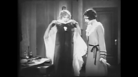 CIRCA 1928 - In this silent comedy, a flapper gives her sister a black negligee to wear for her husband.