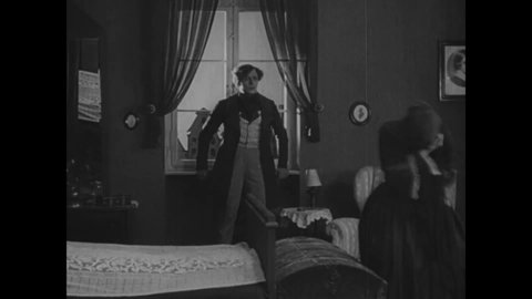 CIRCA 1922 - In this silent horror movie, a woman is afraid because her bedroom window looks out into the insane asylum across the street.