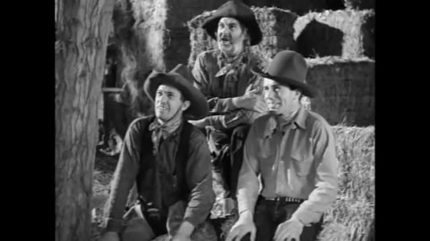 CIRCA 1938 - In this western film, cowboys tease a friend for showering in a barrel.