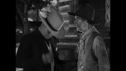CIRCA 1935 - In this western film, Hopalong Cassidy tries to give back a lucky rabbit's foot to the loyal friend who gave it to him but he refuses.