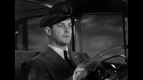 CIRCA 1946 - In this film noir, a gangster controls the speed of his car from the backseat.