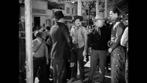 CIRCA 1938 - In this western film, cowboys and miners get into a brawl outside a saloon.