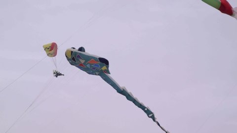 huge kites in the sky with para motor in background