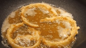 Close up of huge wok while frying homemade onion rings in hot oil and deep pan - Powered by Shutterstock - Get 15% off with code: PIKWIZARD15