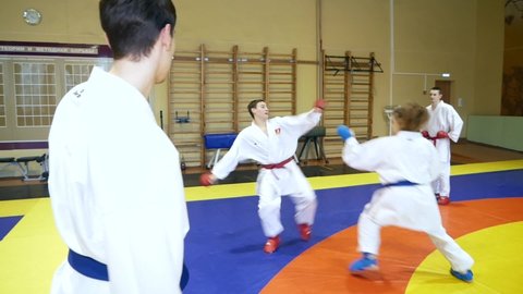 Chelyabinsk, Chelyabinsk region, Russia - 02.06.2022: Athletes group demonstrates martial arts.

Karate student shows blows and tricks.