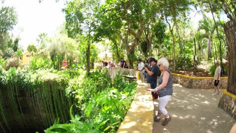 Cenote Ik kil, Yucatan, Mexico - 16 February 2022: Tourist people having great time at the cenote.