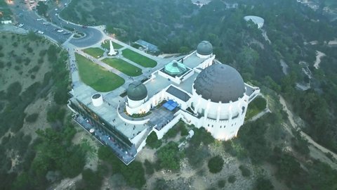 LOS ANGELES, CA, USA - March 15, 2022: Aerial drone shot. Night Los Angeles. flying over Griffith Observatory. downtown Los Angeles skyline. California landmark, travel destination in America.
