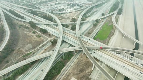 LOS ANGELES, CA, USA - March 15, 2022: Aerial view of highway freeway, cars and trucks on road traffic in Los Angeles. urban modern city in USA, California commute drive in modern city in America.