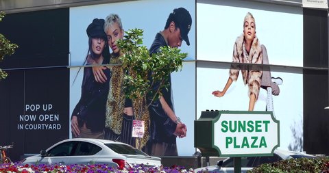 LOS ANGELES, CALIFORNIA, USA - MARCH 19, 2022: Models fashion billboards on Sunset Strip on Sunset Boulevard in Los Angeles, California, 4K